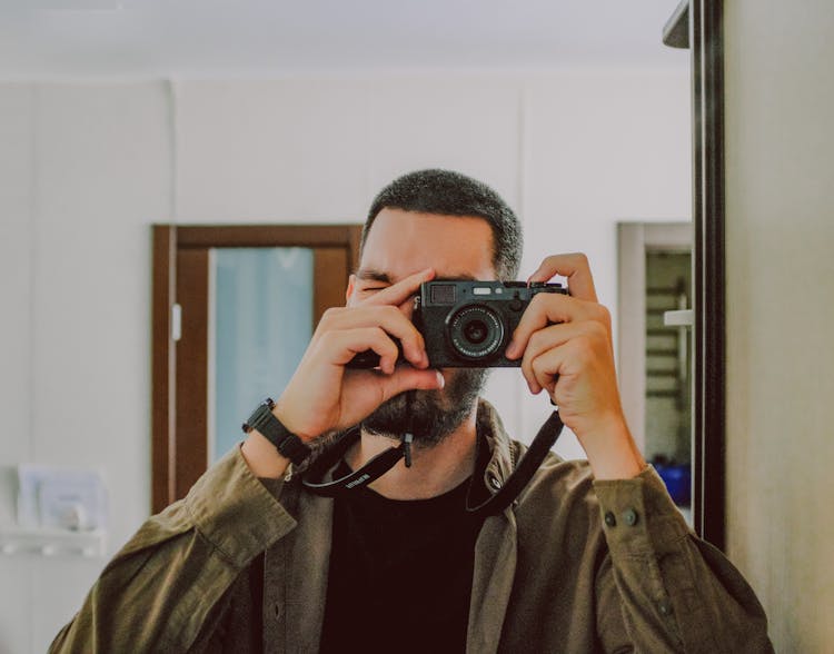 Bearded Man Taking Selfie Near Mirror