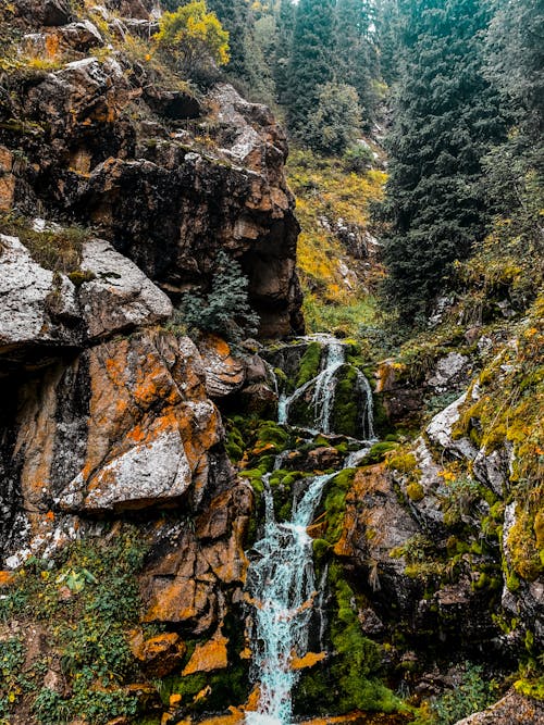 Water Falls Between Brown Rocky Mountain