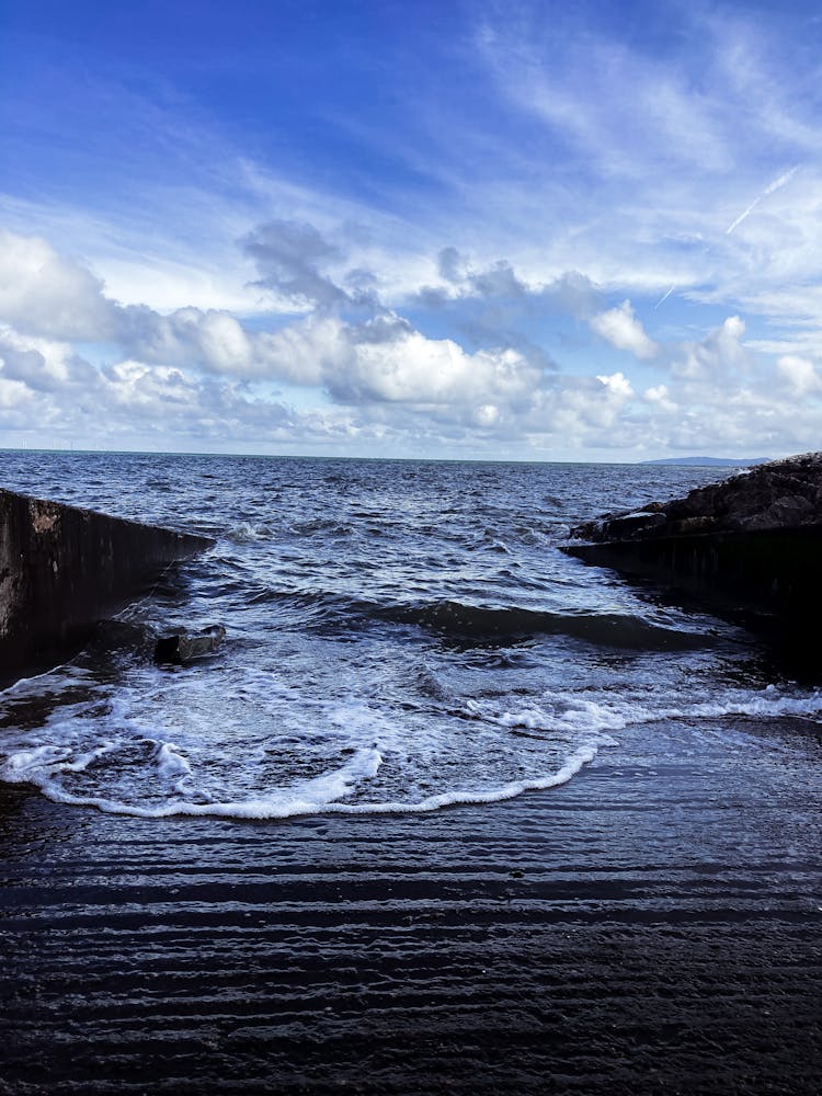 Waves Crashing Over Large Stone Slab