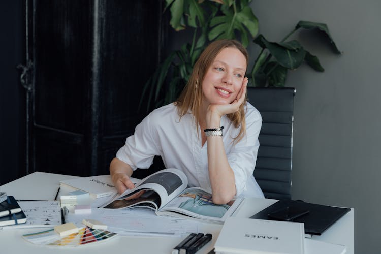 Happy Woman Leaning On A Magazine 