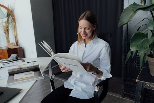 An interior designer is reading a magazine in her modern office, showcasing a professional and creative environment.
