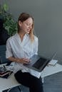 Woman in White Dress Shirt Using Black Laptop Computer