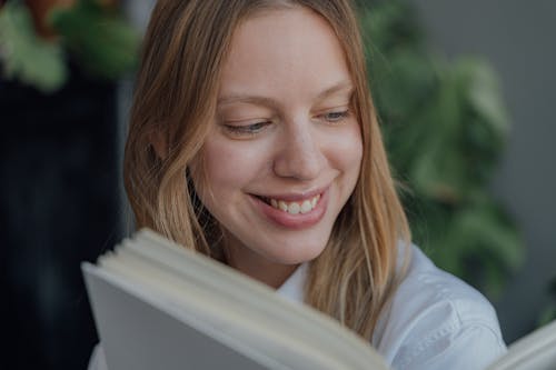 Free Smiling Woman Reading a Book Stock Photo