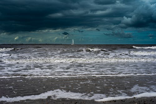 Free Sailboat Sailing under Storm Clouds Stock Photo