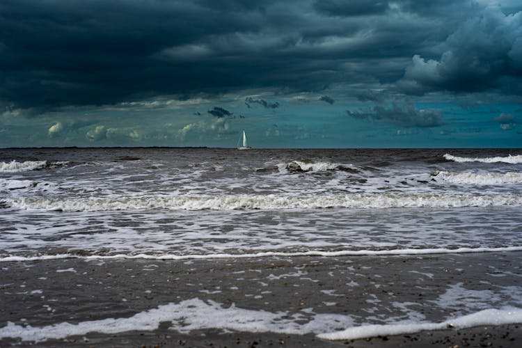 Sailboat Sailing Under Storm Clouds