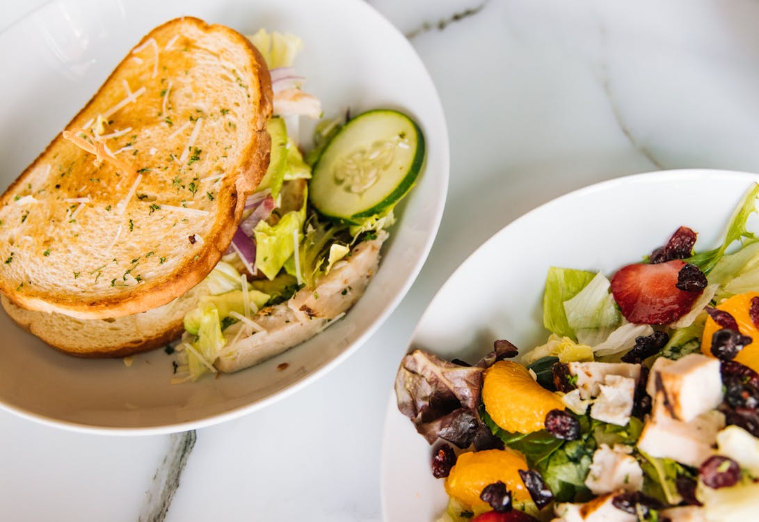 Free Salad and Sandwich on White Plates Stock Photo