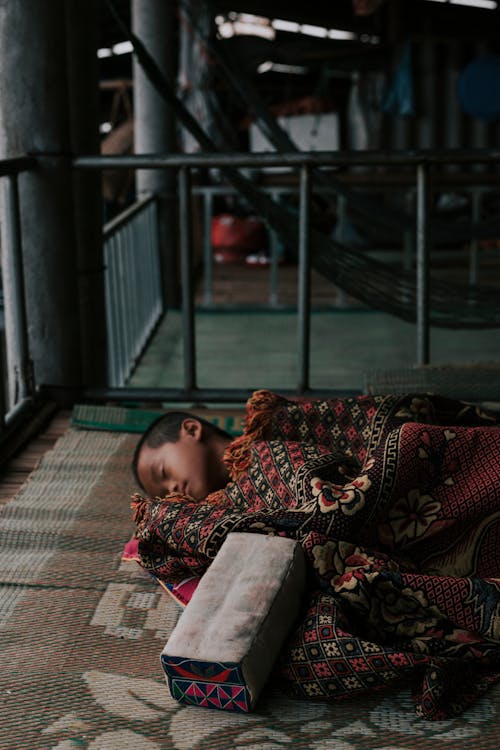 Free Boy Sleeping on Woven Mat  Stock Photo