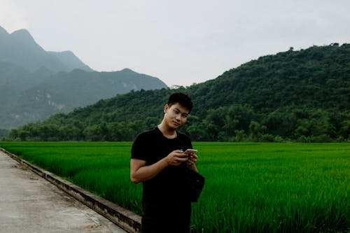 Man Standing Near a Rice Field