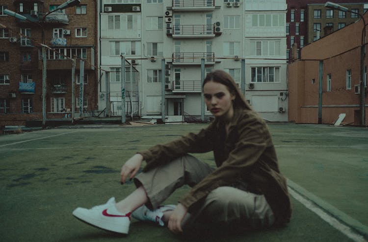 Young Serious Woman Resting On Sports Ground