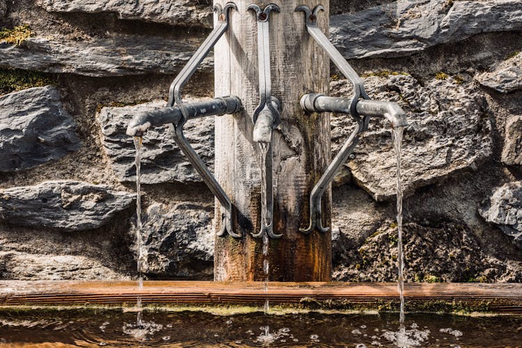 Water Fountain With Taps Near Wall