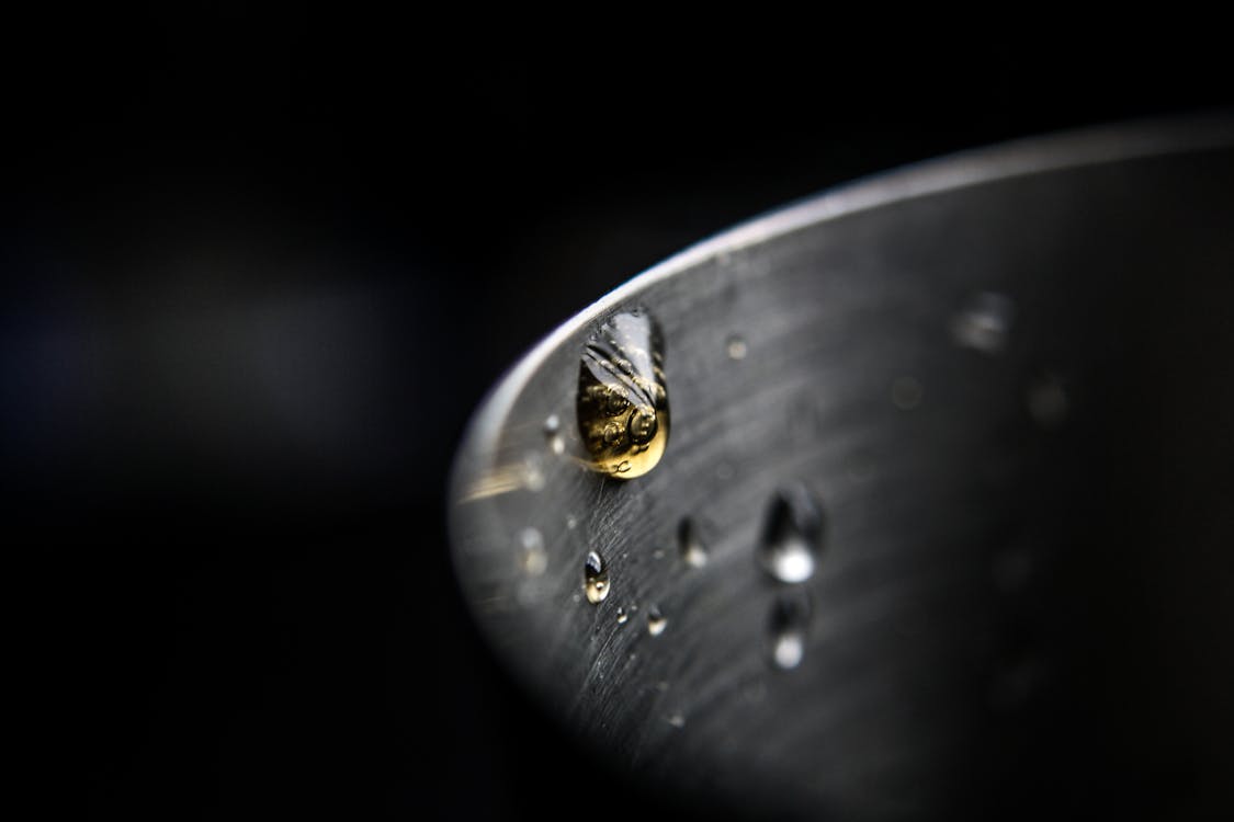 Shallow Focus Photography Of Droplet Of Water
