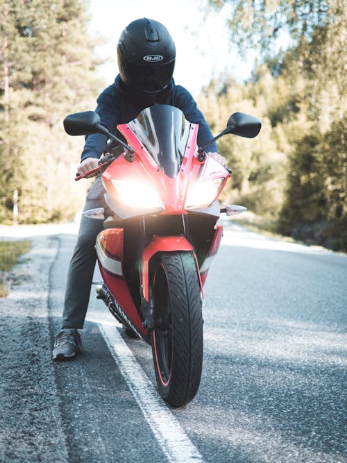 Free Person Riding Red Sports Bike Stock Photo
