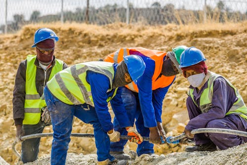 Free Construction Workers Working Together  Stock Photo