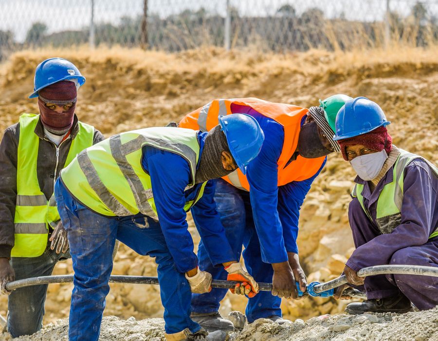 Team of construction workers in safety gear on site in South Africa