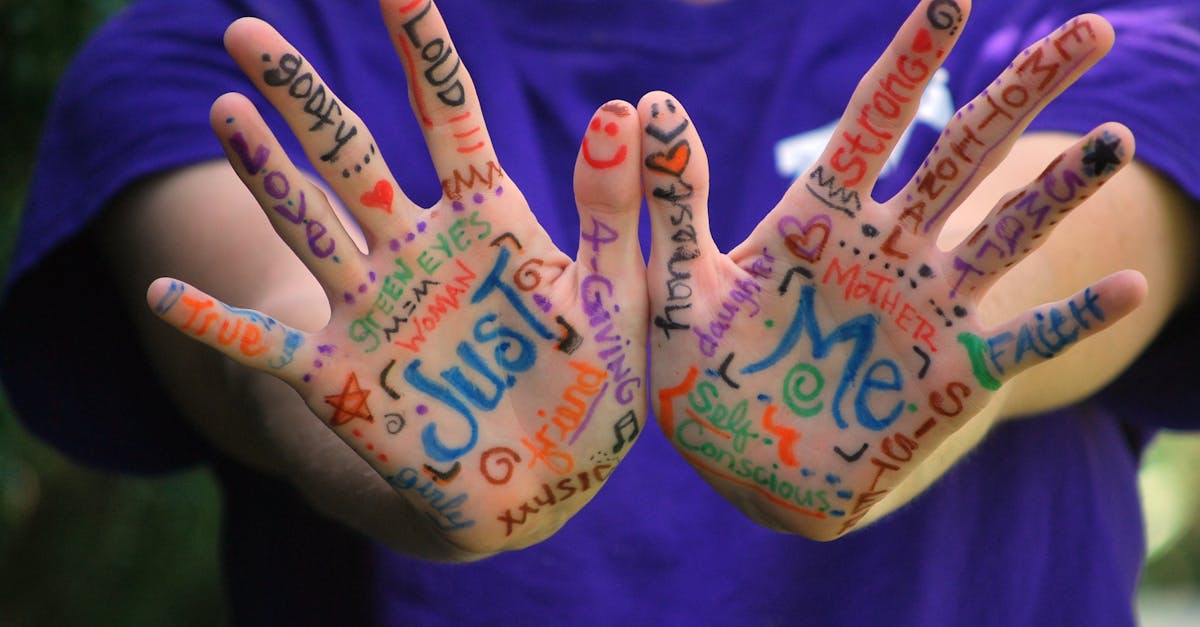 Person in Purple Crew Neck T Shirt With Just Me Painting on Hand · Free