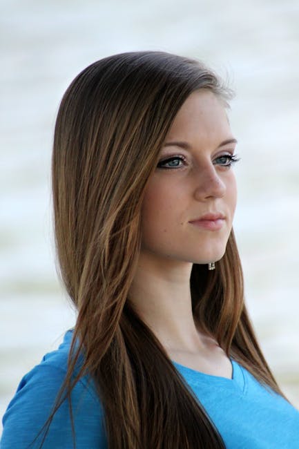 Elegant portrait of a young woman with long hair in a serene setting.