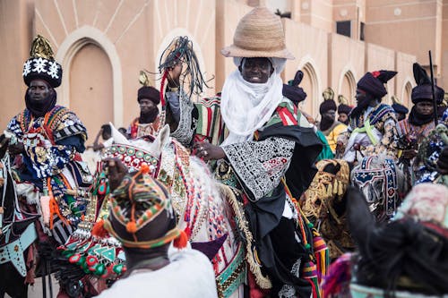 Men in Traditional Costumes Riding Horses 