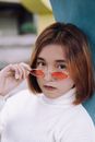 Woman in White Turtleneck Sweater Wearing Red Sunglasses