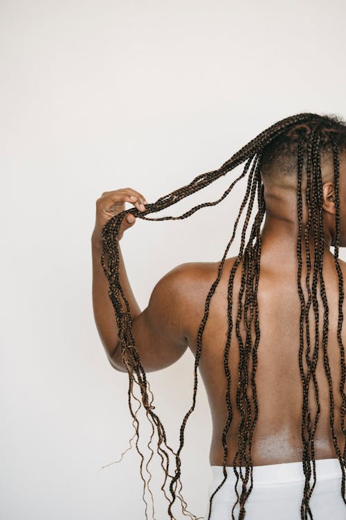 Crop shirtless black man with Afro braids