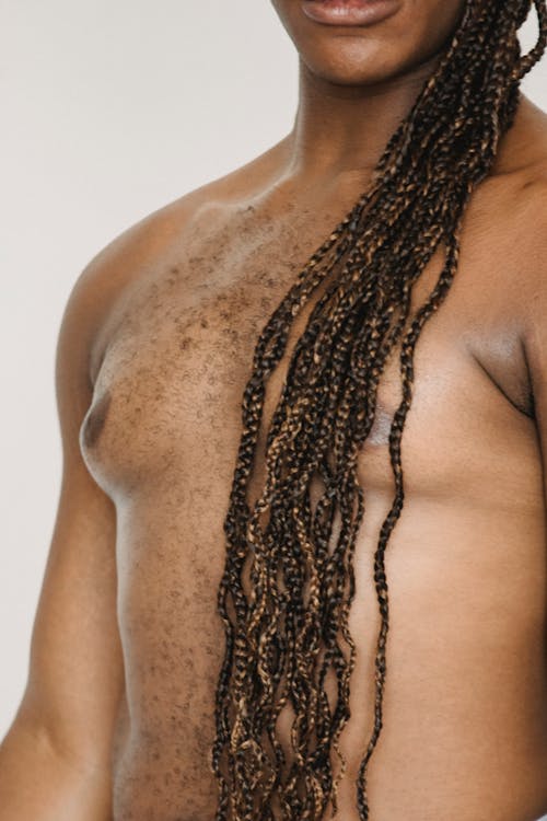 Crop shirtless black man in studio