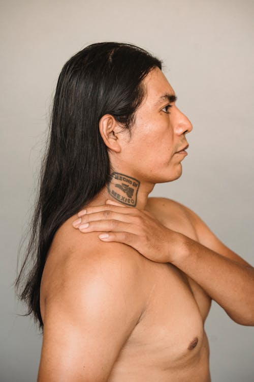 Native American man with tattoo and naked torso
