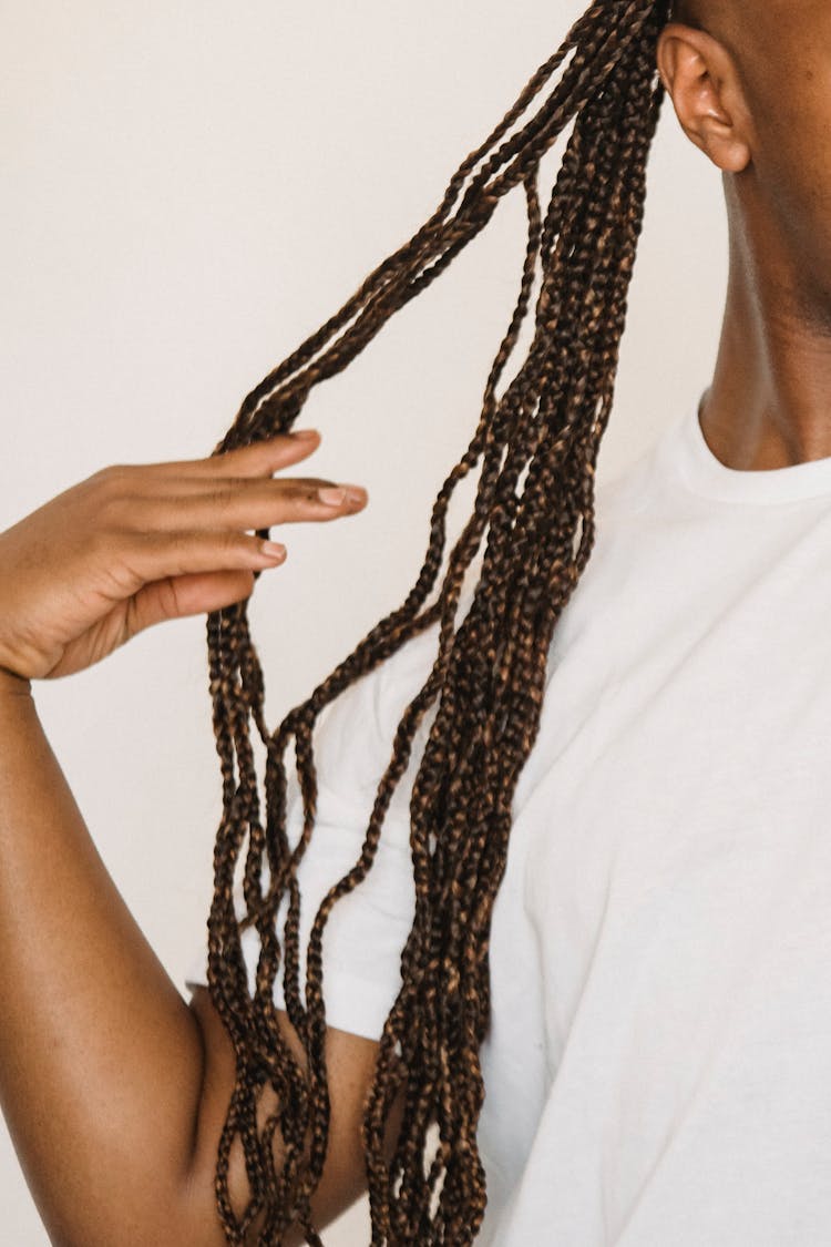 Crop Anonymous Black Man With Long Braids Touching Hair