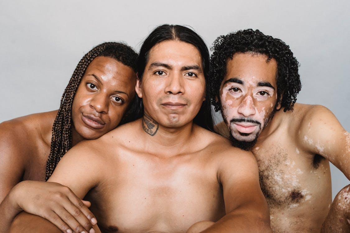 Free Multiethnic friends with naked torso in studio Stock Photo
