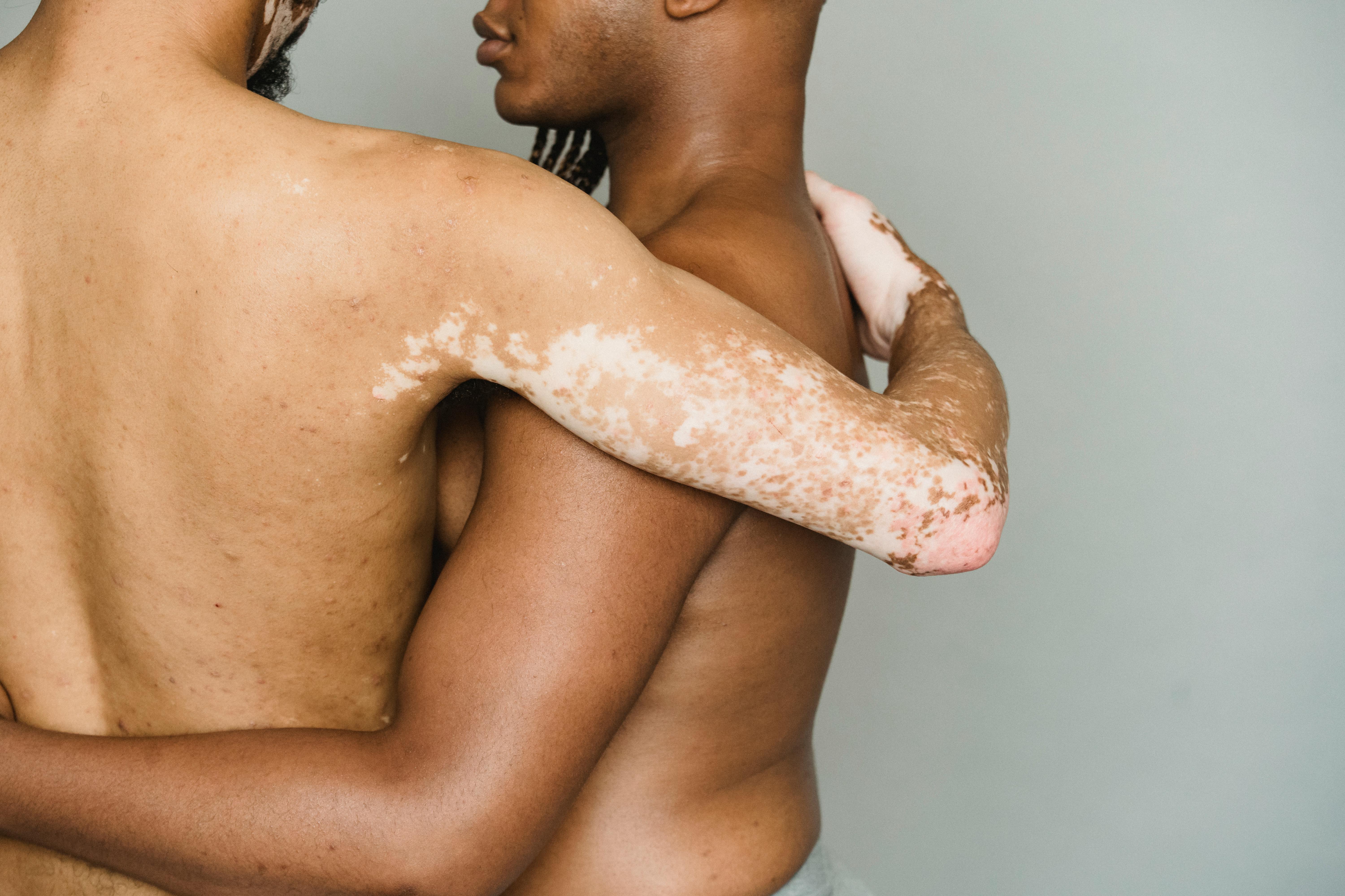 diverse homosexual men hugging in studio