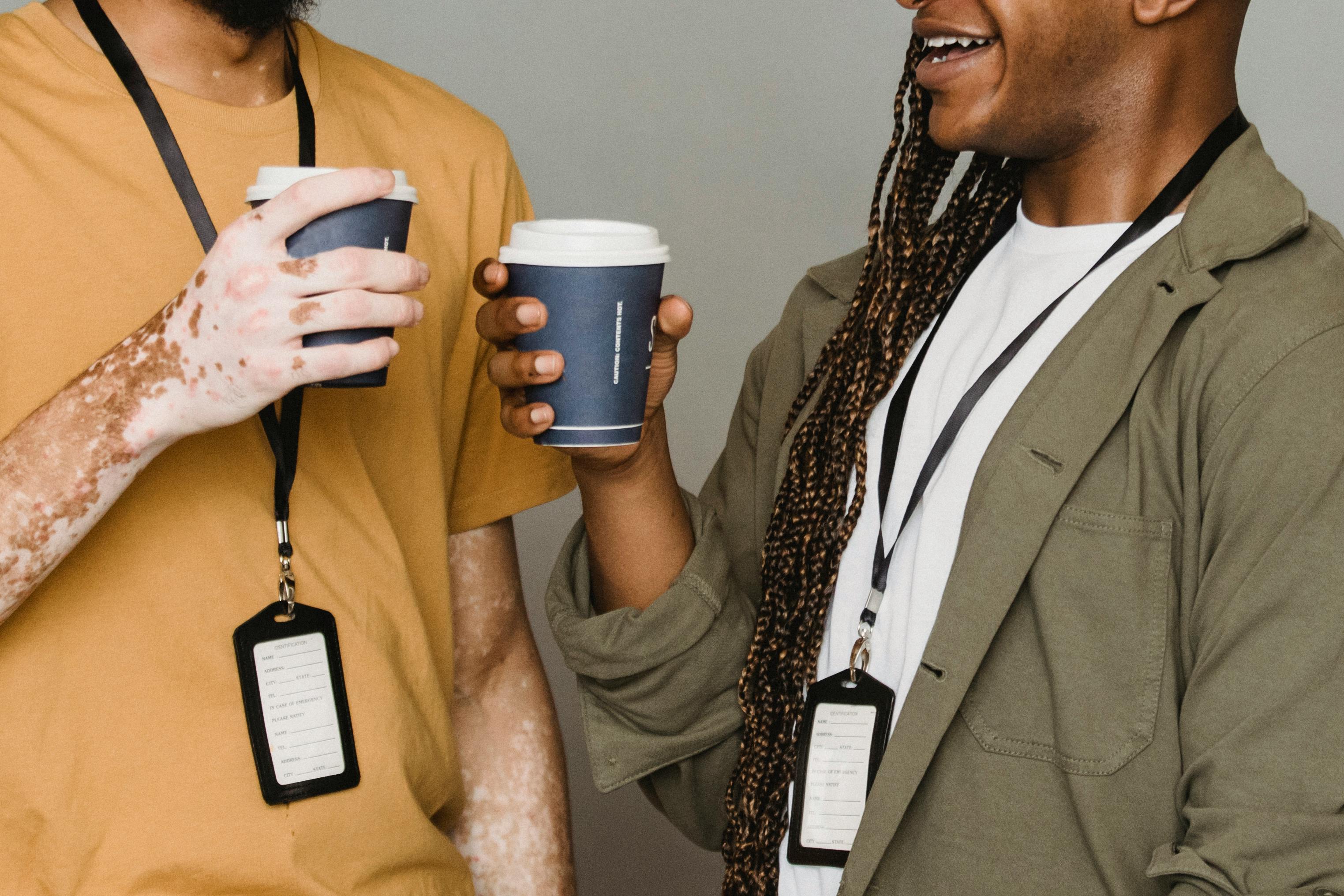 smiling black man with braids having coffee with friend