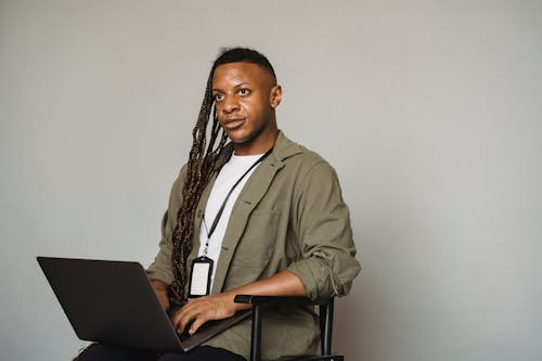 Free Black transgender man working on laptop Stock Photo