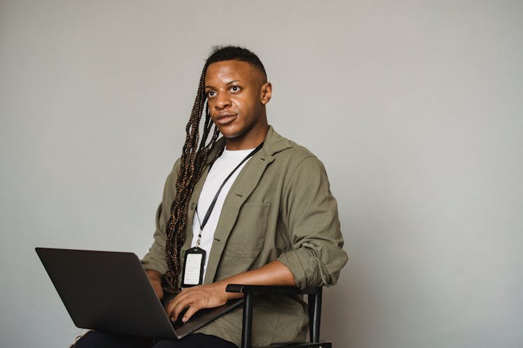 Black Transgender Man Working On Laptop