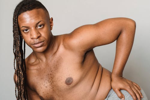 Shirtless feminine black man in studio