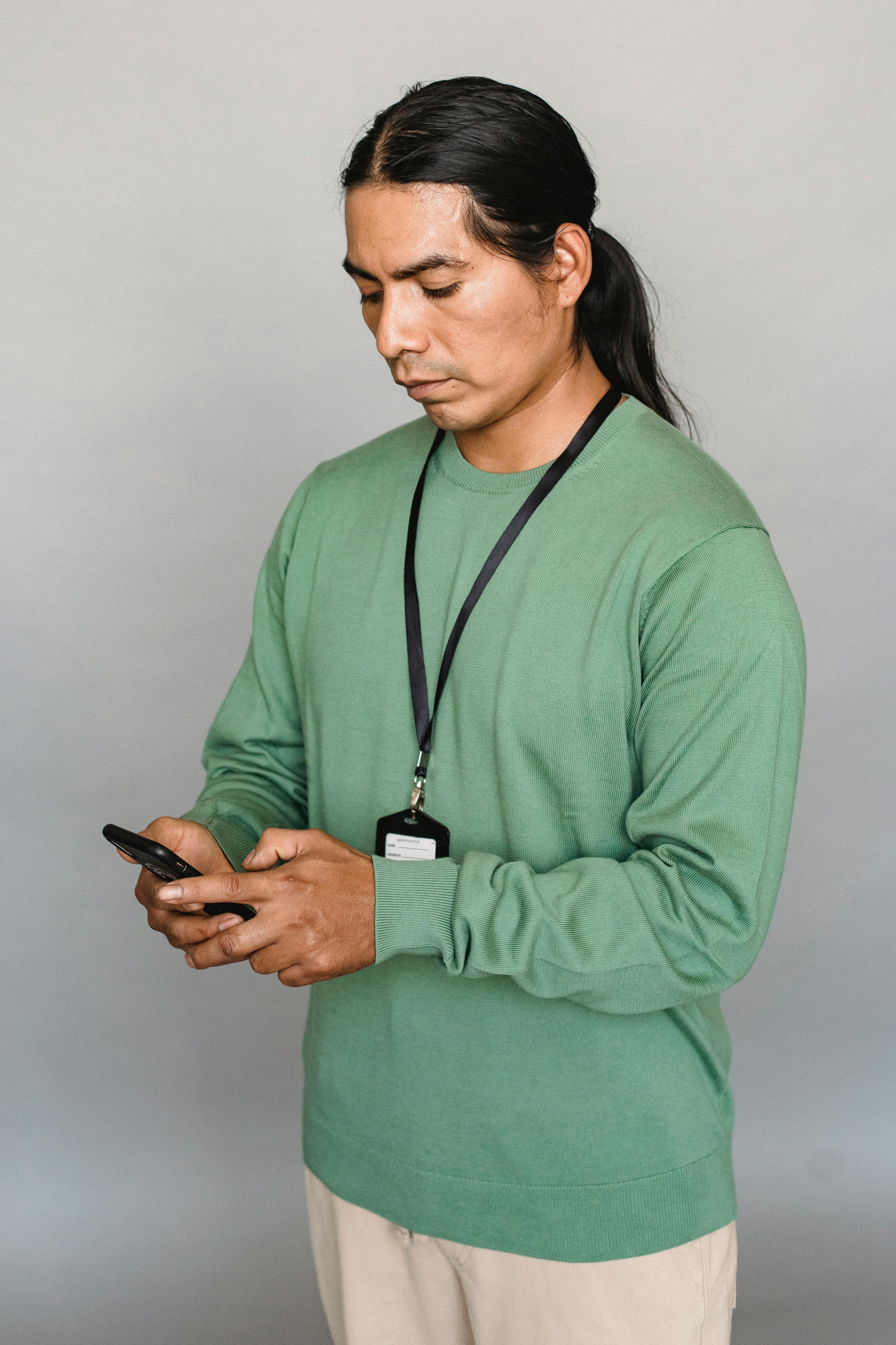 indian man browsing smartphone in studio