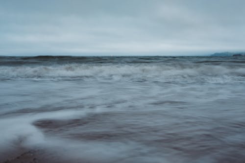 Big Waves Crashing Under Gloomy Sky