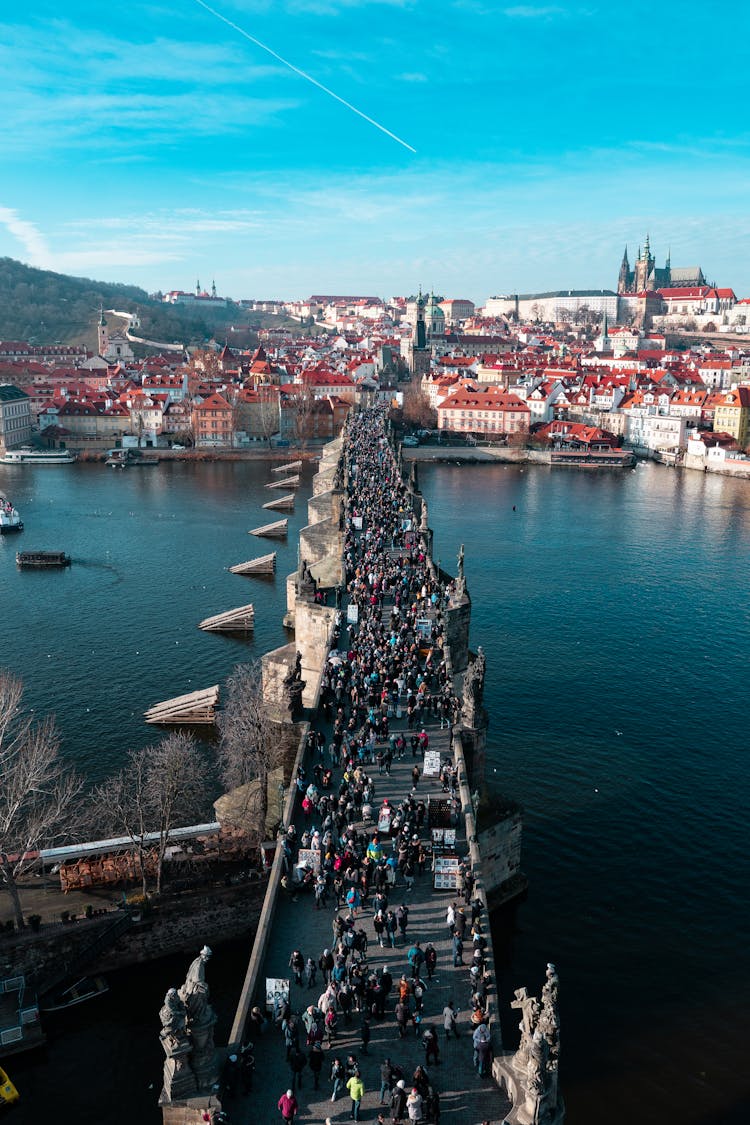 Drone Shot Of People Walking On The Concrete Bridge