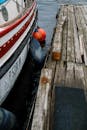 A Wooden Boat Docked Beside a Wooden Dock