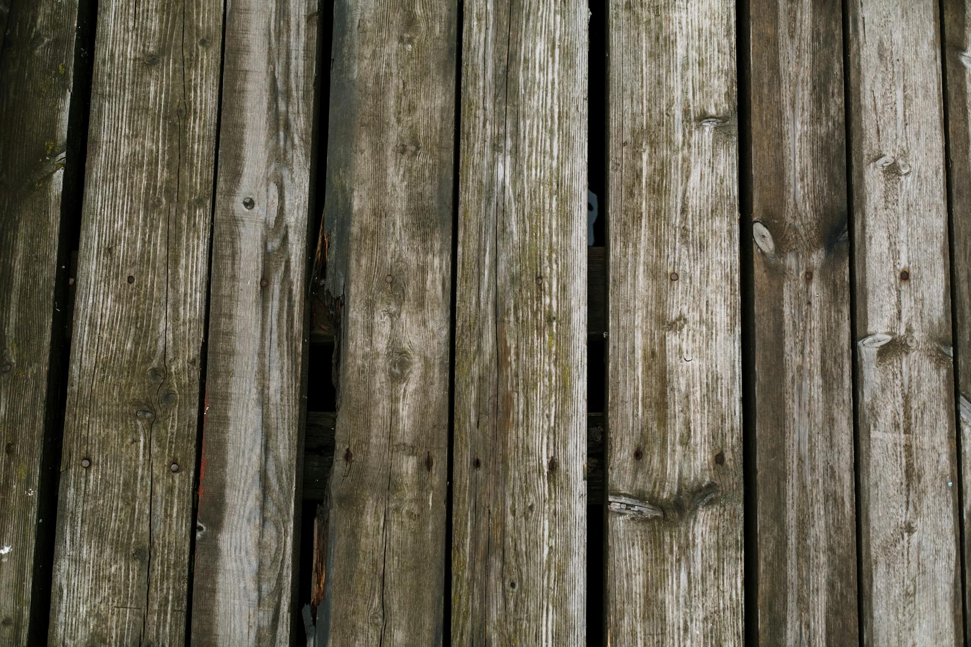 Close-up of aged wooden planks, ideal for rustic or natural-themed flooring designs.