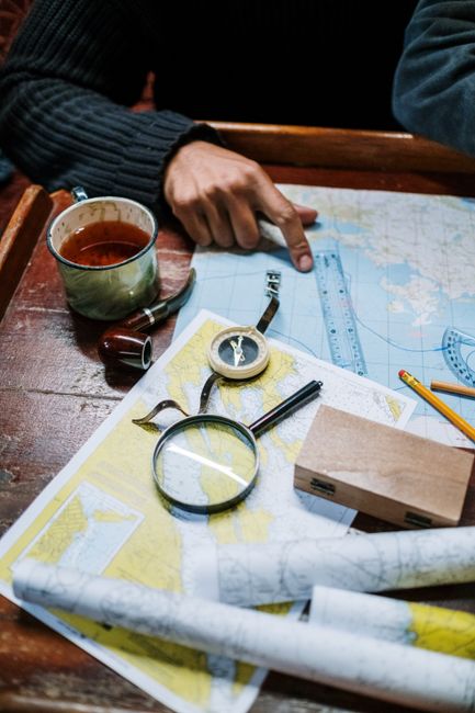 hands planning travel route on map