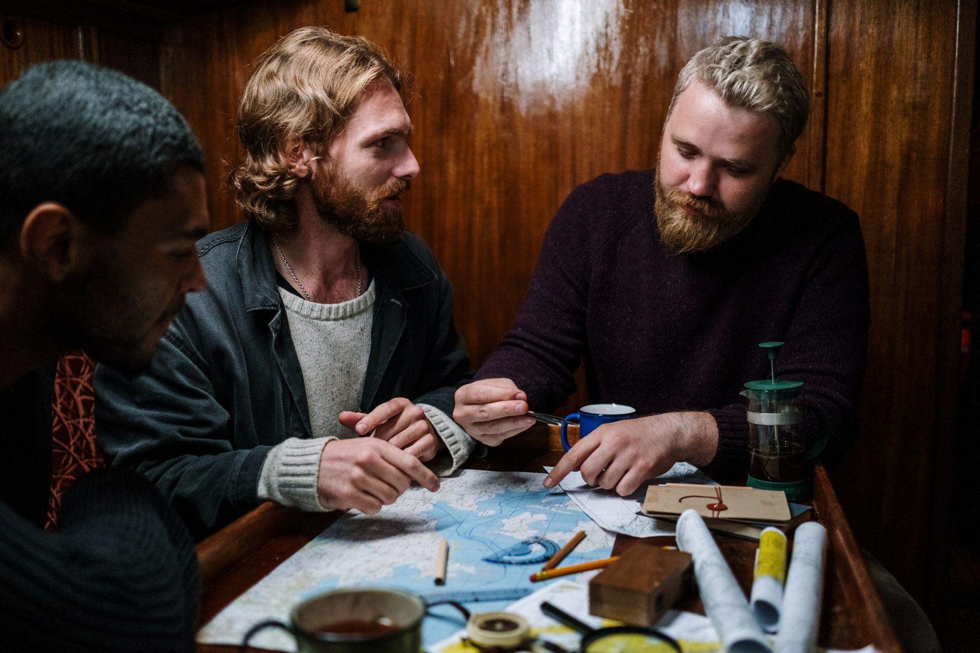 Men having Discussion over Maps and Navigation