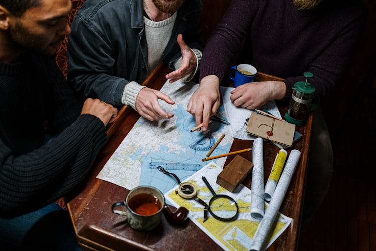 Men Planning A Route Using Map 