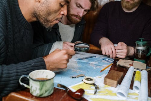 Men looking at a Map using Magnifying Glass