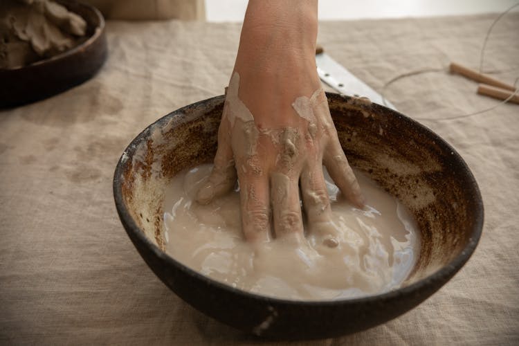 Crop Ceramist With Hand In Clay