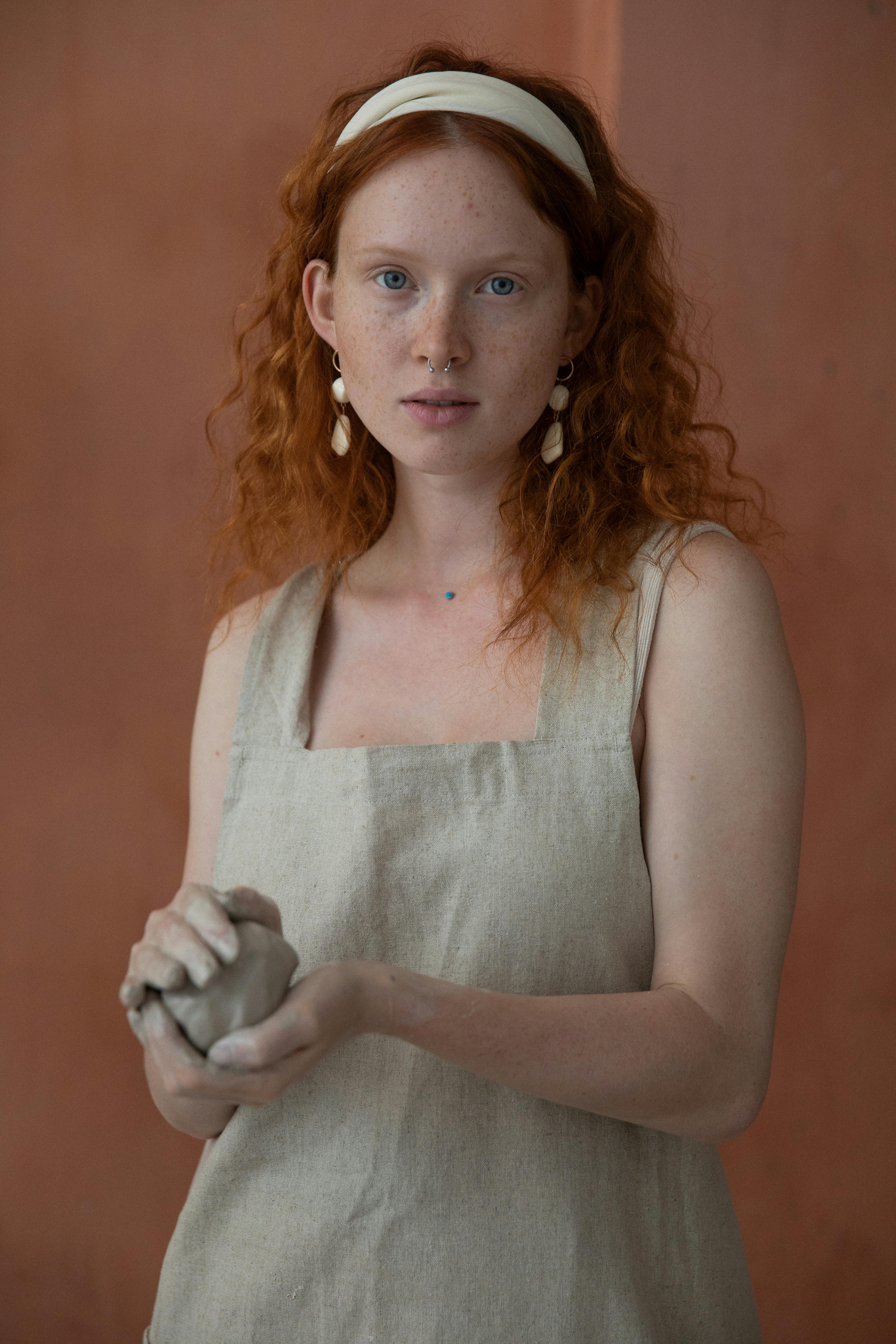 calm redhead woman with clay