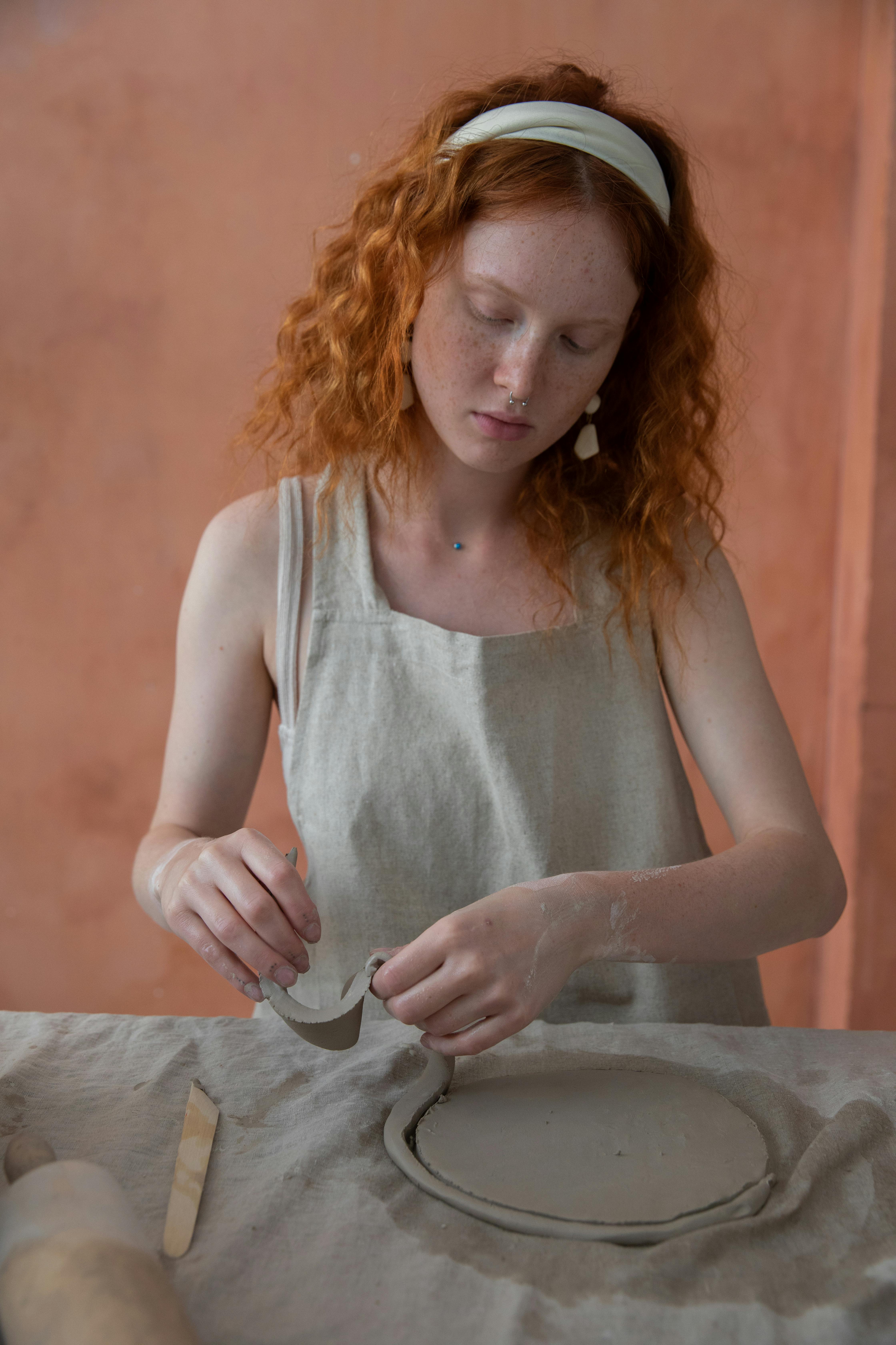 redhead woman working with clay