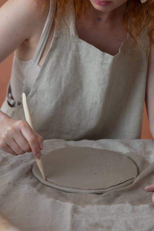 Ritaglia La Donna Creando Stoviglie In Officina