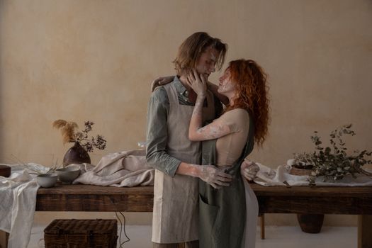 Gentle couple in clay embracing each other