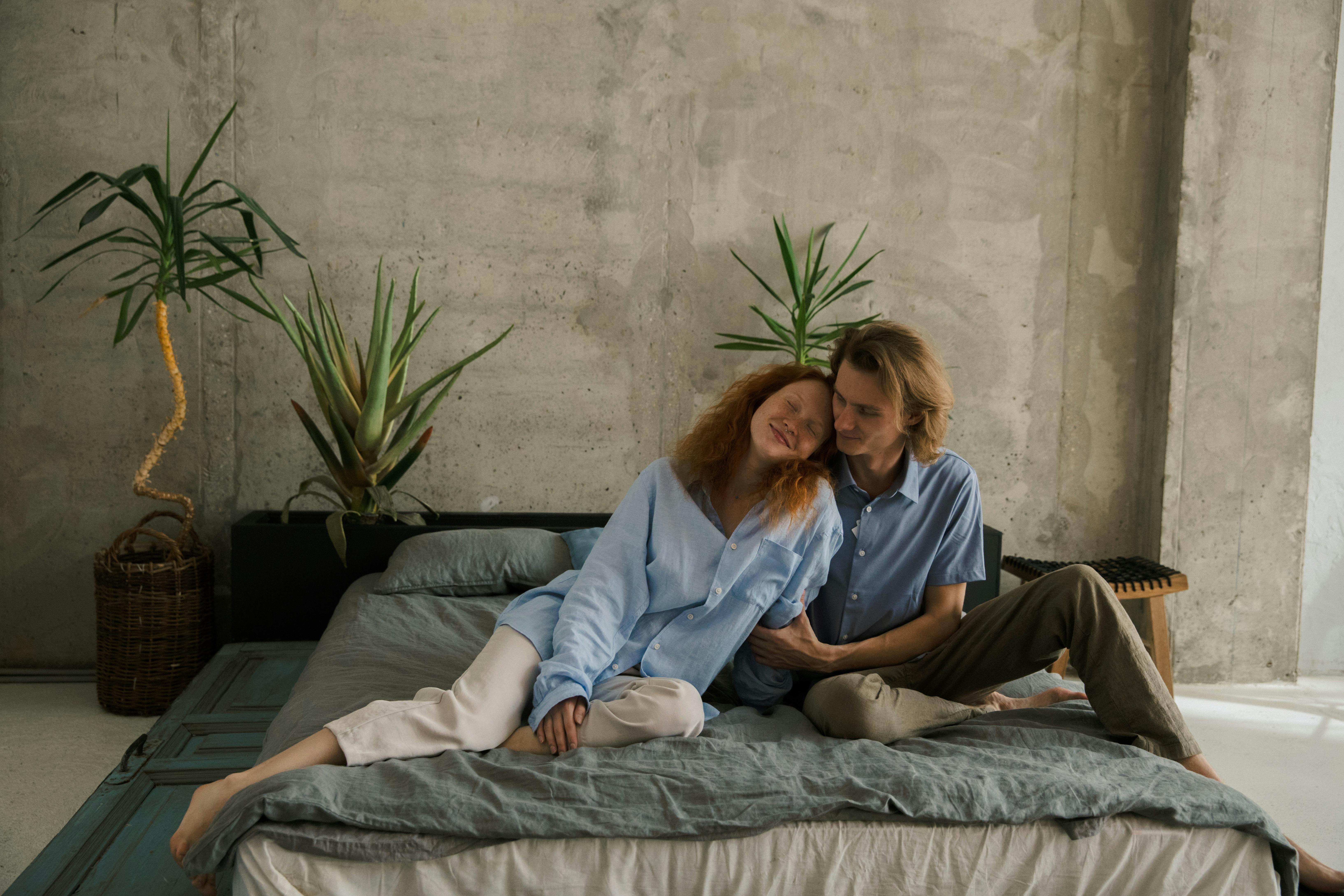 happy couple resting on bed