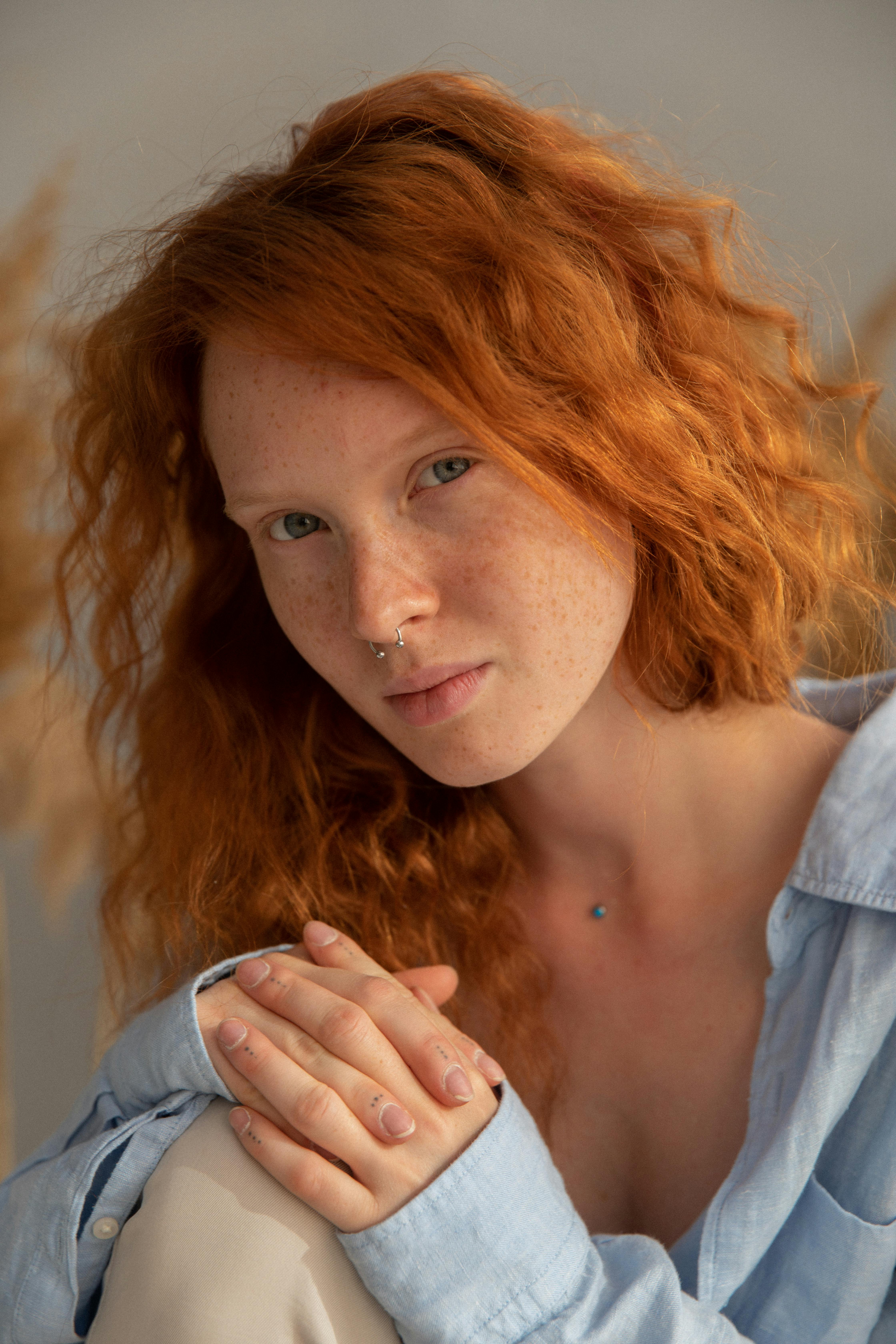 dreamy ginger woman with clasped hands