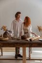 Romantic couple near table with pottery