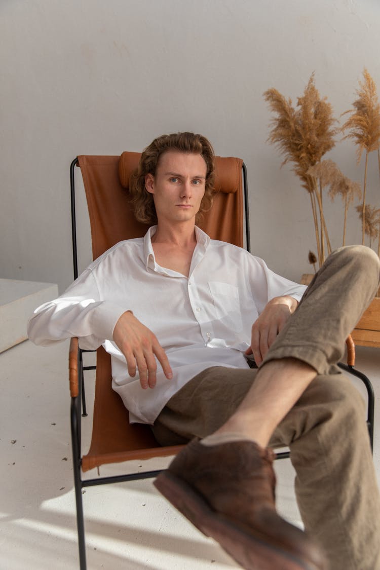 Thoughtful Man Sitting On Armchair